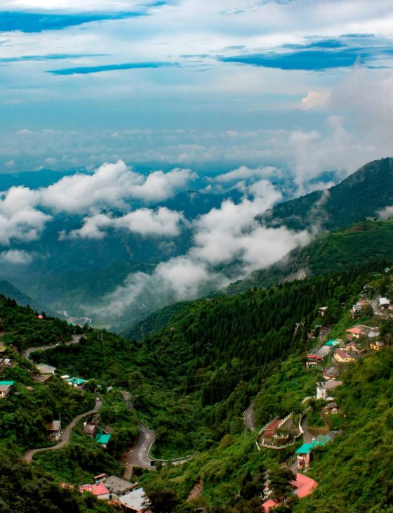 Captivating view of lush mountains and clouds in Mussoorie, India, showcasing natural beauty.
